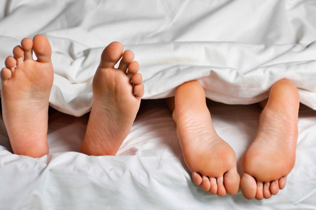 Couple lying in bed after avoiding a fight