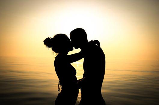 silhouette of couple kissing during the sunset