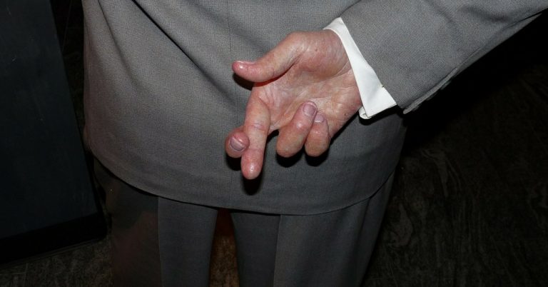 Man with deceptive fingers crossed