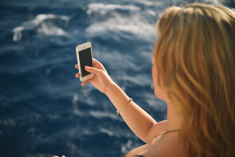woman taking selfie showing sexy games to play when apart