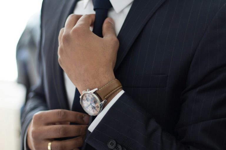 Man in a black suit wearing a watch