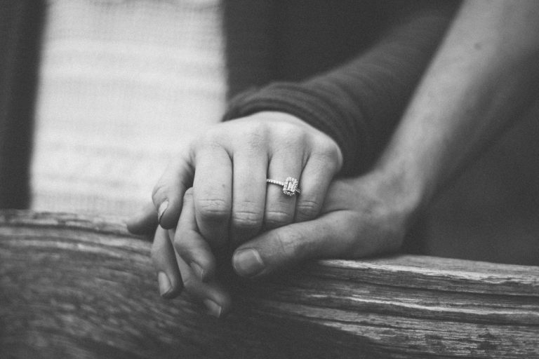Married couple holding hands for support
