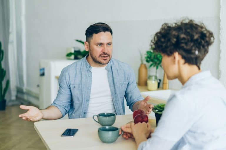 Husband and wife talking through a disagreement at the table