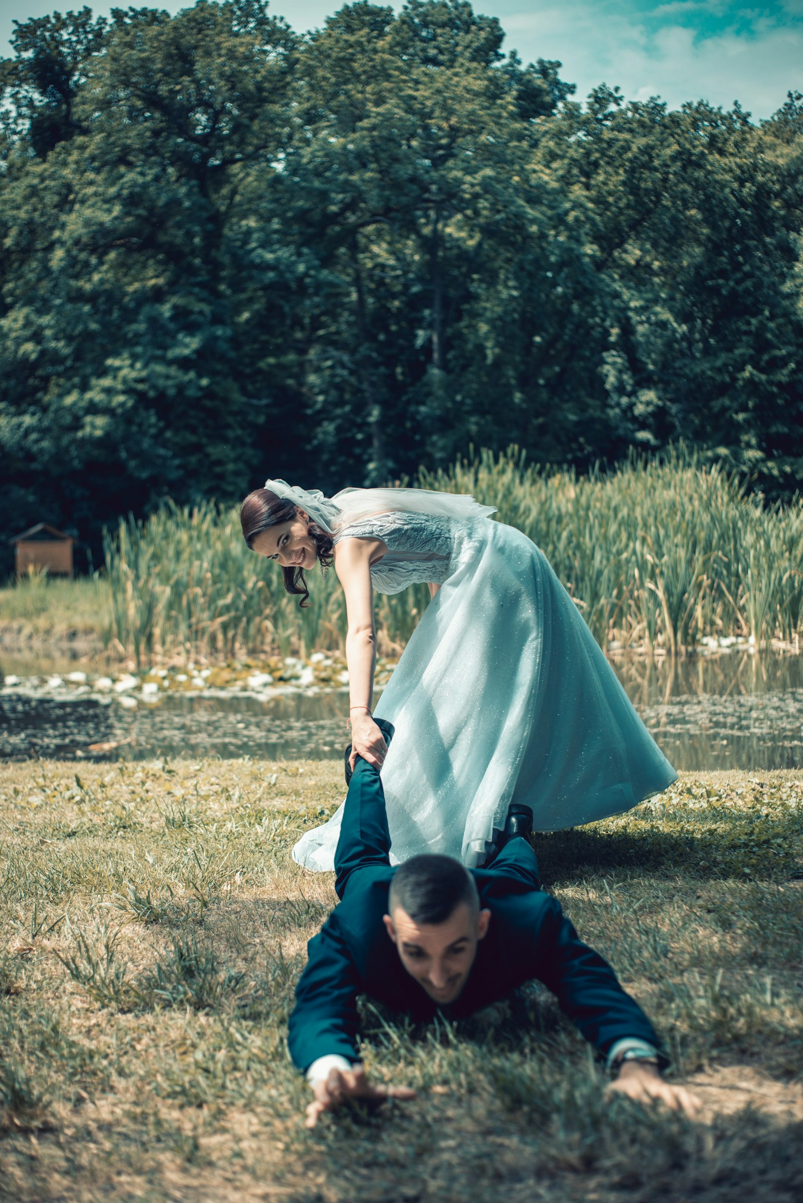 Engaged couple kissing in a grassy field during their photo shoot