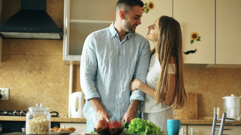 Husband and wife cooking together in the kitchen