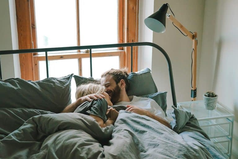 Husband kissing his wife on the forehead