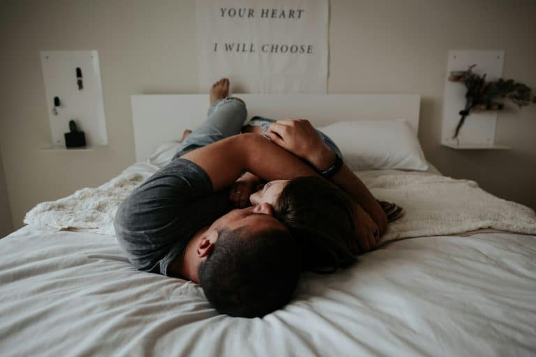 Married couple cuddling in bed