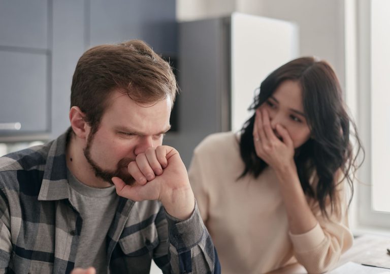 Couple looking worried during a difficult conversation at home