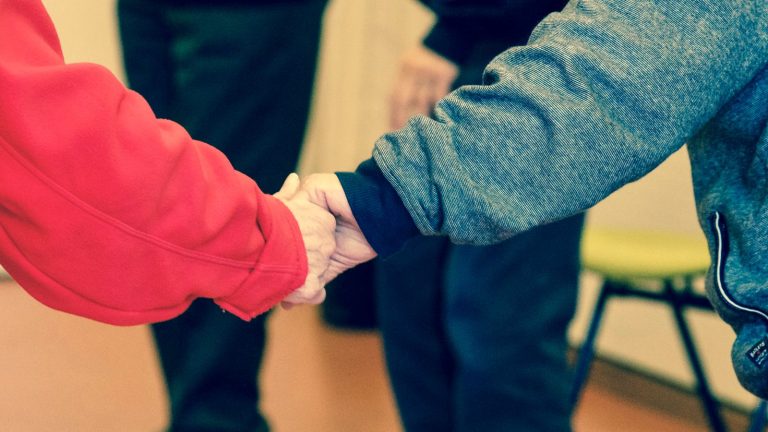 Couple holding hands as a sign of support and forgiveness