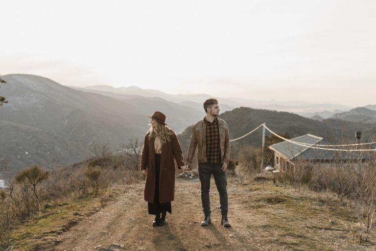 Couple holding hands outdoors, celebrating their marriage
