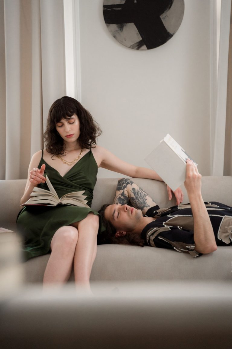 Couple sharing a room while enjoying different hobbies