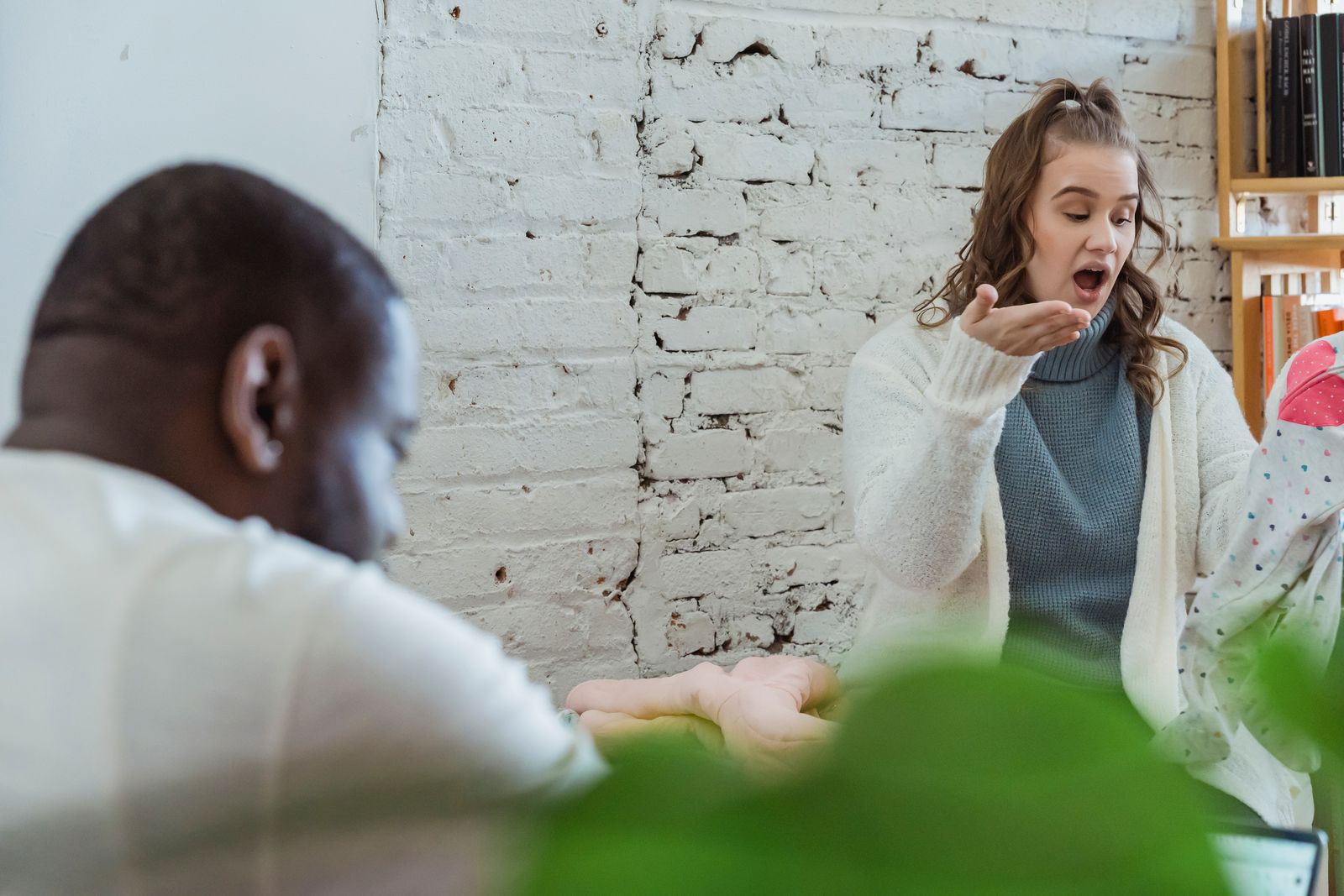 Wife explaining something to her husband who is not quite listening