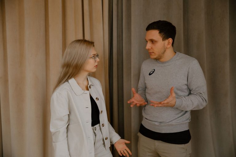 Husband and wife talking through a disagreement at home